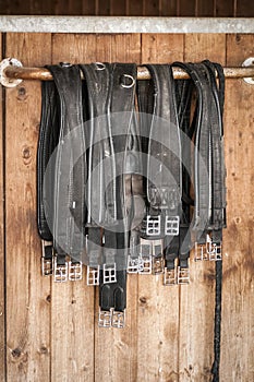 Girths in front of a stable door