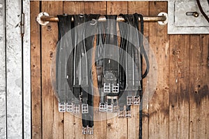 Girths in front of a stable door