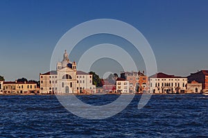 Giudecca and Church of Santa Maria della Presentazione over water at sunset, in Venice, Italy photo