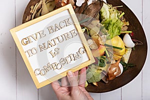Give back to nature is composting motivation text with organic garbage for compost