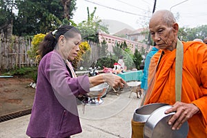 Give food offerings to a Buddhist monk in Morning