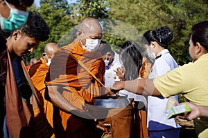 give food offerings to a Buddhist monk On the occasion of Thai Father's Day , 5 December 2023 , Buriram Thailand.