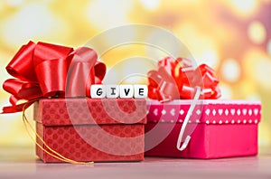 Give gift concept - Giving a gift box present wrapped with red ribbon for Christmas time holiday or valentines day