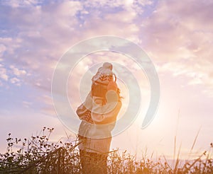 Give the gift on the Day of LoveRomantic girl walking in a field in sunset light. Winter, autumn life