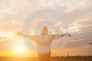 Give the gift on the Day of LoveRomantic girl walking in a field in sunset light. Winter, autumn life