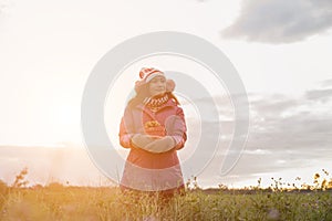 Give the gift on the Day of LoveRomantic girl walking in a field in sunset light. Winter, autumn life