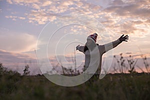 Give the gift on the Day of LoveRomantic girl walking in a field in sunset light. Winter, autumn life