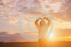 Give the gift on the Day of LoveRomantic girl walking in a field in sunset light. Winter, autumn life