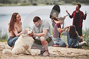 Give me look at you. Group of people have picnic on the beach. Friends have fun at weekend time