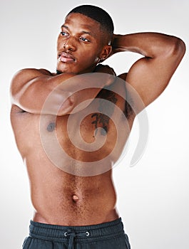 Give me mouth to mouth and make amends. Studio shot of a shirtless handsome young man posing against a white background. photo