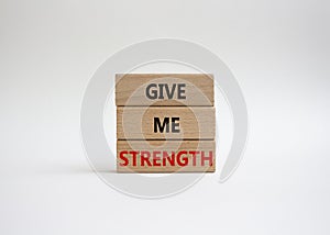 Give me strength symbol. Concept word Give me strength on wooden blocks. Beautiful white background. Business and Give me strength