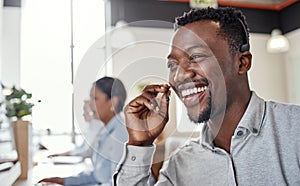 Give me your concerns and Ill get them resolved. a young man using a headset in a modern office.