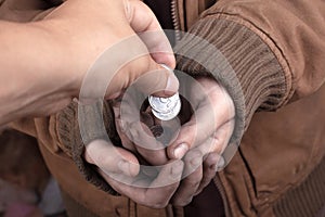 Give out coins to the poor,do good deeds,donation photo