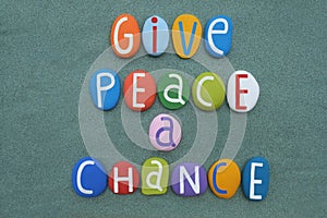 Give peace a chance, creative social issue phrase compose with multi colored stone letters