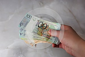 Give, take, banknotes of Belarusian rubles in a hand