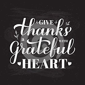 Give thanks with a grateful heart calligraphy hand lettering on chalkboard background. Thanksgiving Day inspirational
