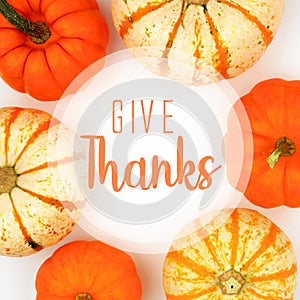 Give Thanks greeting card with frame of pumpkins over white photo