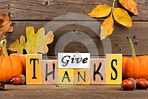 Give Thanks wood sign with pumpkins and leaves