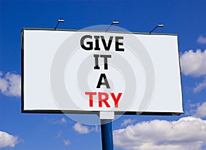 Give it a try symbol. Concept word Give it a try on beautiful big white billboard. Beautiful blue sky cloud background. Business