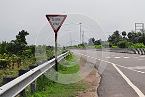 Give way sign on the side of national highway double road