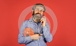 Give your brand the due attention. young man talking on telephone. senior hipster old telephone. brutal guy with