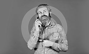 Give your brand the due attention. young man talking on telephone. senior hipster old telephone. brutal guy with