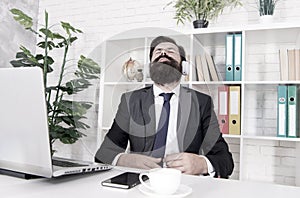 Give yoursel a break. Businessman relax during break time. Bearded man listen to music at work break. Employer in formal