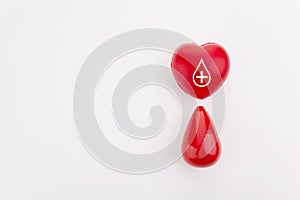 Giving blood saves live. Blood Donation concept. Red heart and blood drop on white background