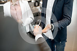 Giving a car keys to a couple in the showroom