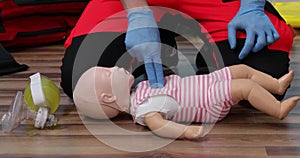 Giving first aid on a child dummy. Practitioners training medical learning on a baby mannequin. Emergency course for resuscitation