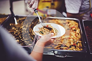 Giving free food to the homeless. Volunteers feed ChiangMai`s hungry and homeless meal