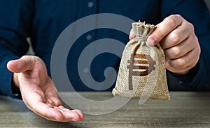 Giving gesture and philippine peso money bag.