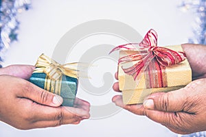 Giving gift box in with hands On special days for special person and copy space background