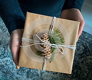 Giving a gift, handmade present wrapped in paper
