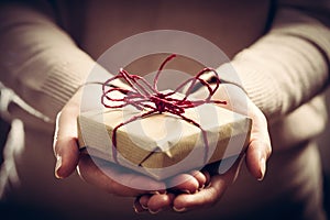 Giving a gift, handmade present wrapped in paper