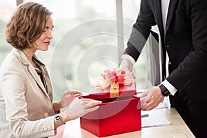 Giving gifts to employees at the office on Christmas day photo