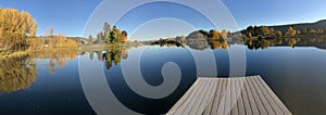 Glorious fall colors reflected on Frenchtown Pond dock photo