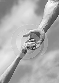Giving a helping hand. Hands of man and woman on blue sky background. Lending a helping hand. Solidarity, compassion
