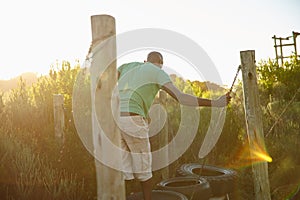 Giving himself a pep talk before moving on. a man going across an obstacle at bootcamp.