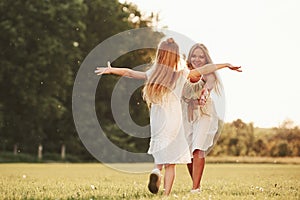 Giving hugs. Mother and daughter enjoying weekend together by walking outdoors in the field. Beautiful nature