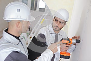 Giving instruction to builder to drill wall