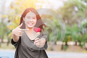 Giving love gift, Asian woman hand hold give beautiful red heart sweet loving