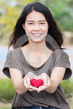 Giving love in valentine`s day , Asian woman hand hold give beautiful red heart sweet loving.