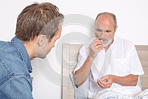 Giving medication to an elderly man