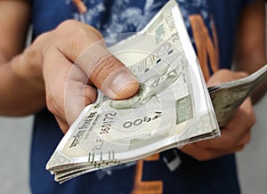 Giving money, Indian currency of 500 rupee note cash in hand, investment, banking,
