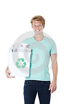 Giving paper a second chance. A friendly young red-headed man holding a recycling bin filled with newspapers.