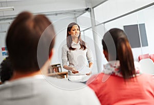 Giving a presentation. A young woman giving a presentation in front of her colleagues.