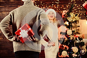 Giving and sharing. Winter surprise. Man carry gift box behind back defocused background. Christmas surprise concept