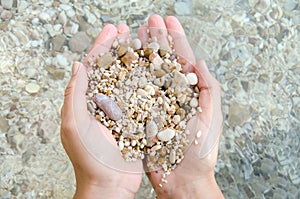 giving smooth zen pebble in hand conceptual and inspirational 