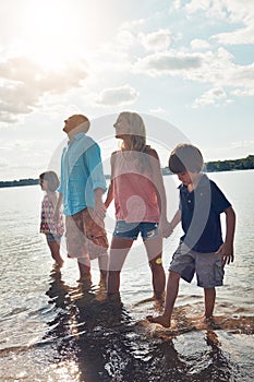 Giving their children the prized gift of time. a beautiful family spending some quality time on the beach.